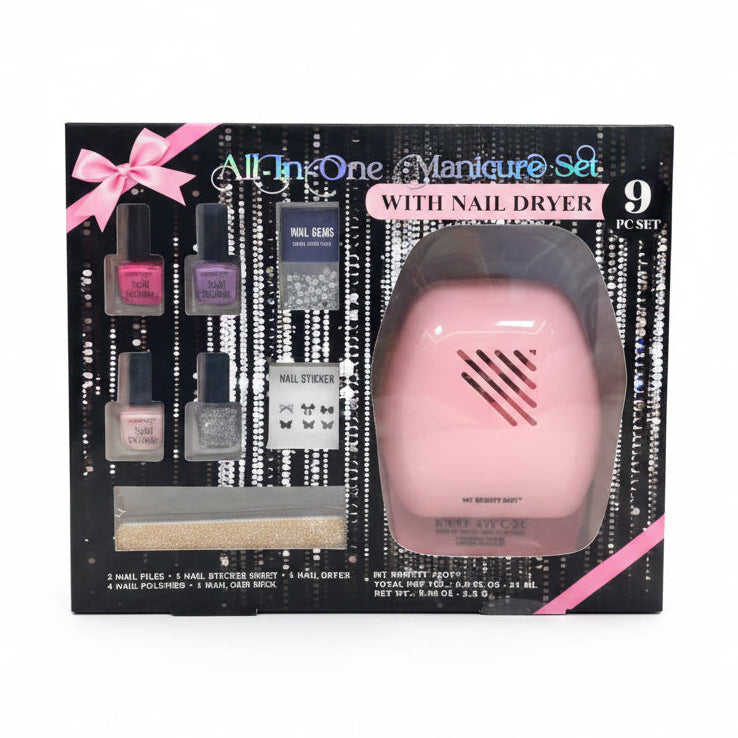An all-in-one manicure set in retail packaging, featuring a pink nail dryer inside a clear plastic window and several nail polish bottles, nail gels, nail stickers, and a nail file on a black and silver background with pink ribbon accents.