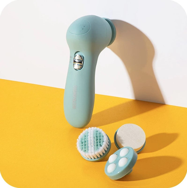 Blue facial cleansing brush with interchangeable heads on yellow and white surface.