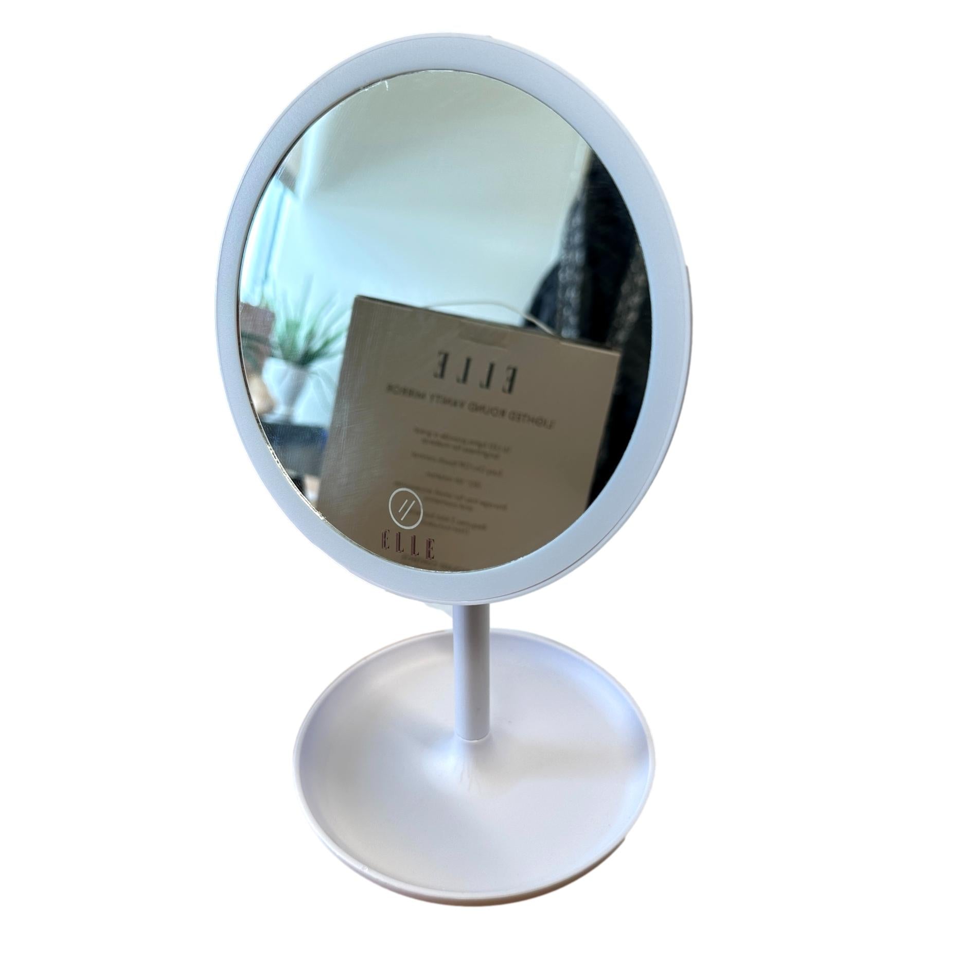 White round 16-LED vanity mirror by Wholesale, standing on a base with 'ELLE' text and a touch control icon.