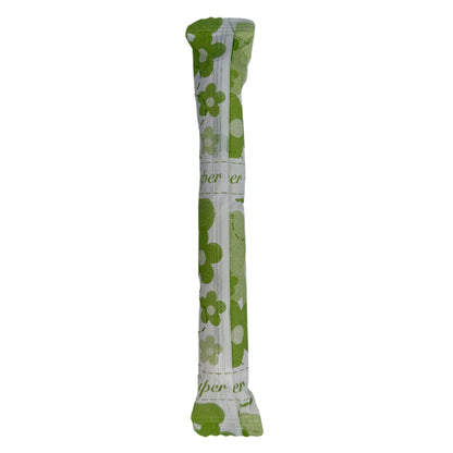 Wrapped tampon with green floral design.