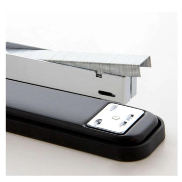 A black stapler with silver staples.