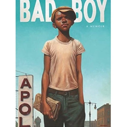 Book cover of "Bad Boy: A Memoir" featuring a young Black boy in a cap, t-shirt, and jeans, holding a book in front of a sign reading "APOL".