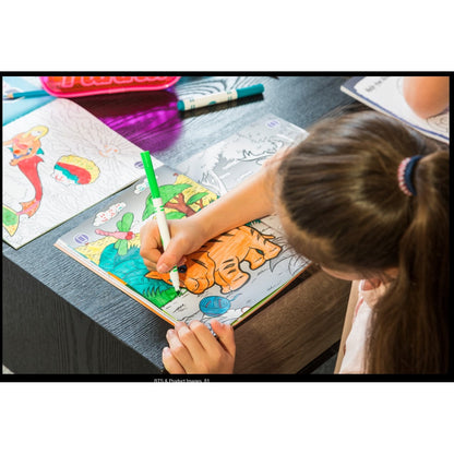 A girl coloring a tiger in a coloring book with a green marker.
