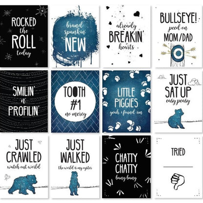 A collection of cards with humorous baby milestones and sayings.