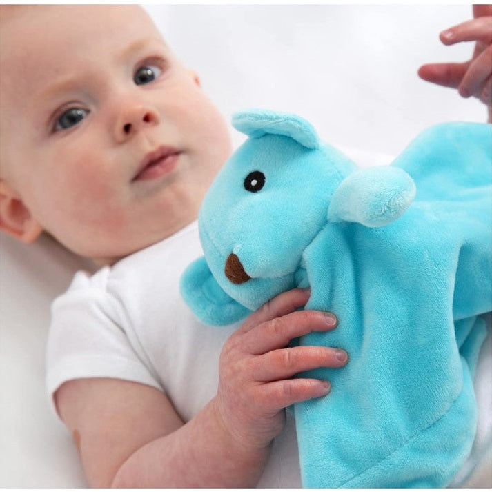 A baby holding a blue plush toy.