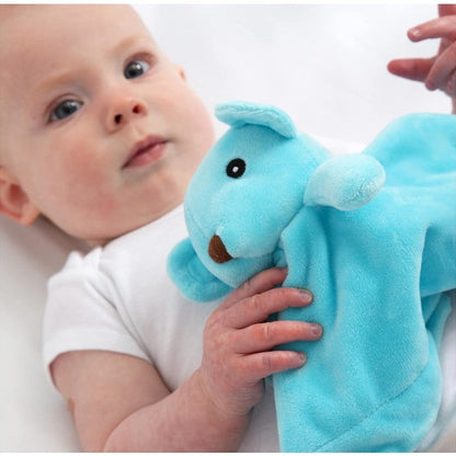A baby holding a blue plush toy.