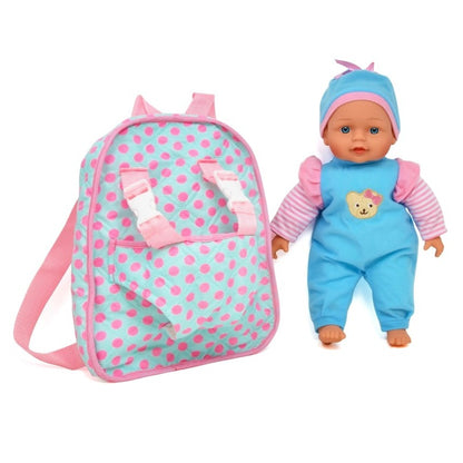 A baby doll in a blue outfit next to a polka dot backpack.