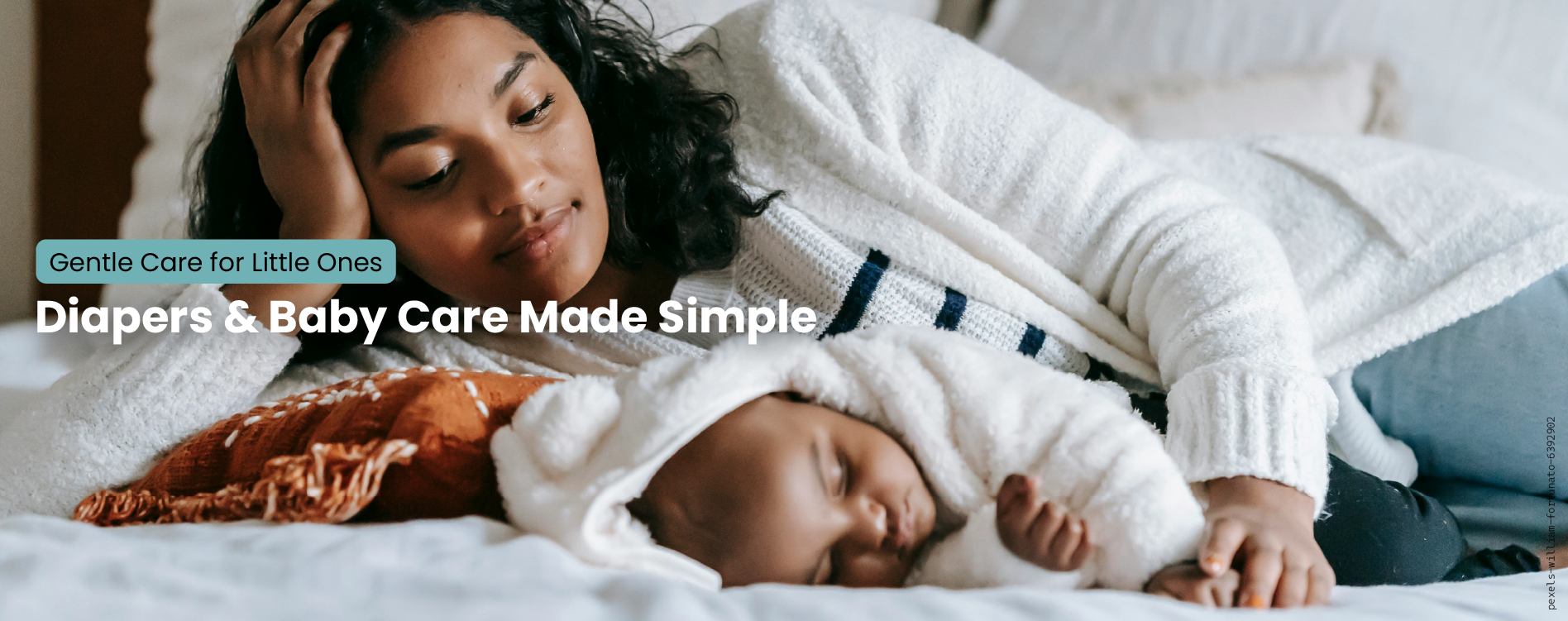 Woman lying on a bed with a baby, both wearing white sweaters, with text about diapers and baby care.