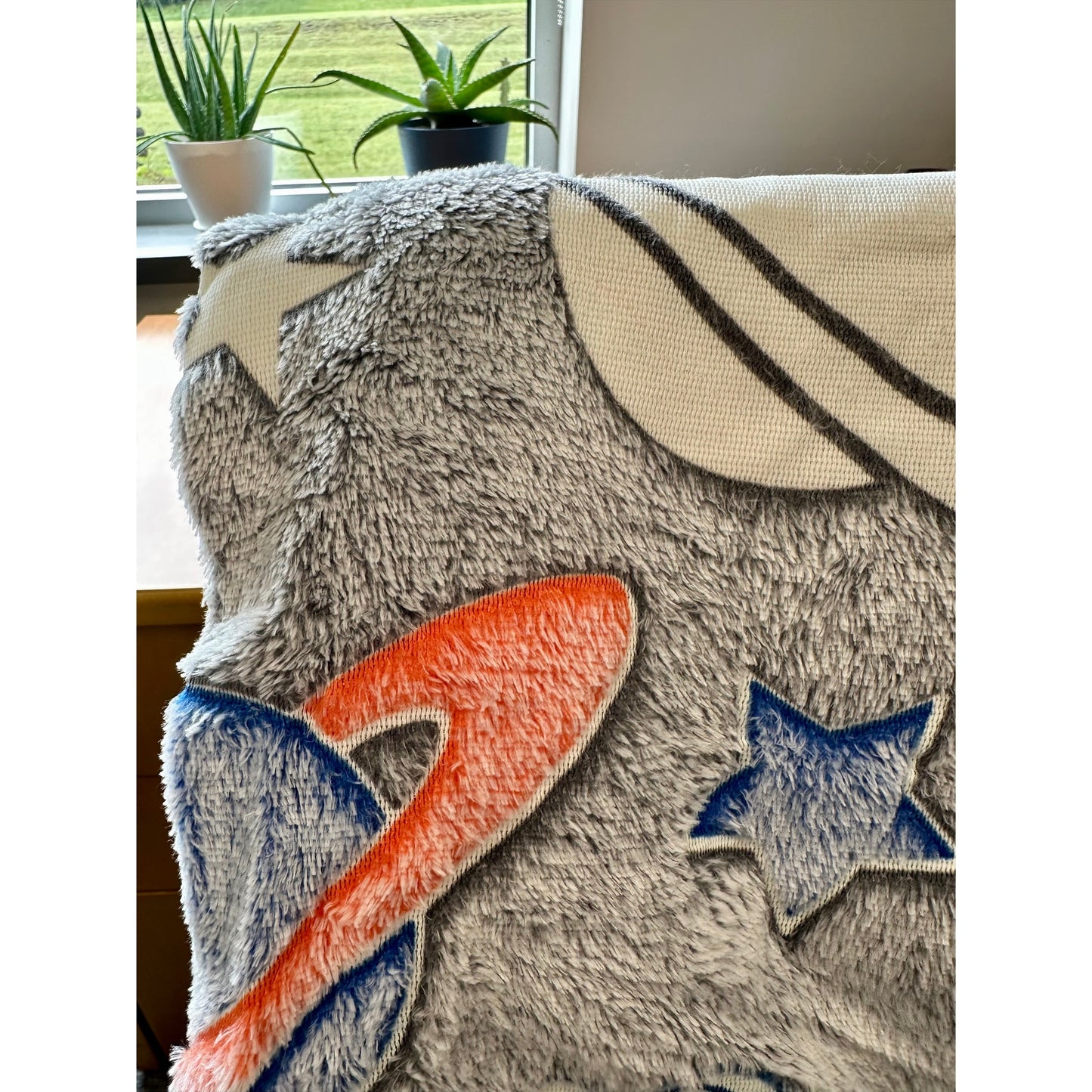 Fuzzy blanket with stars and stripes design.