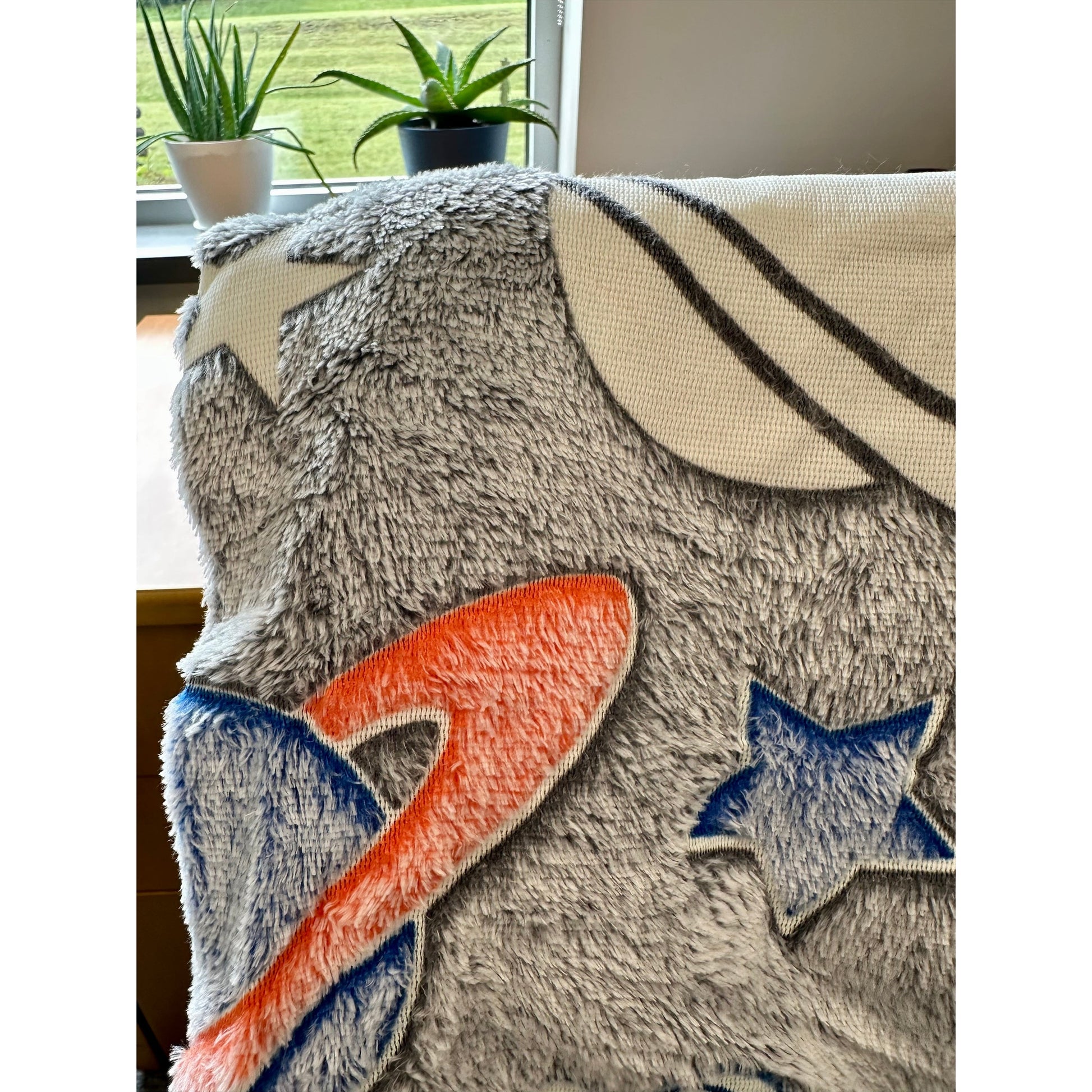 Fuzzy blanket with stars and stripes design.