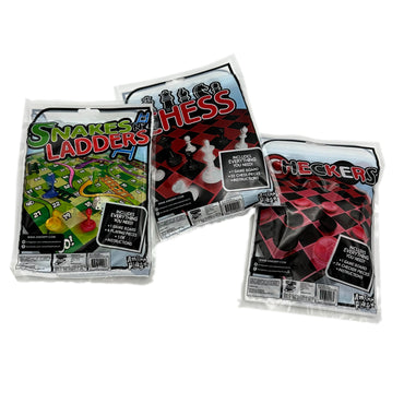 Three plastic-wrapped board games, "Snakes N' Ladders," "Chess," and "Checkers," are stacked on a white surface.