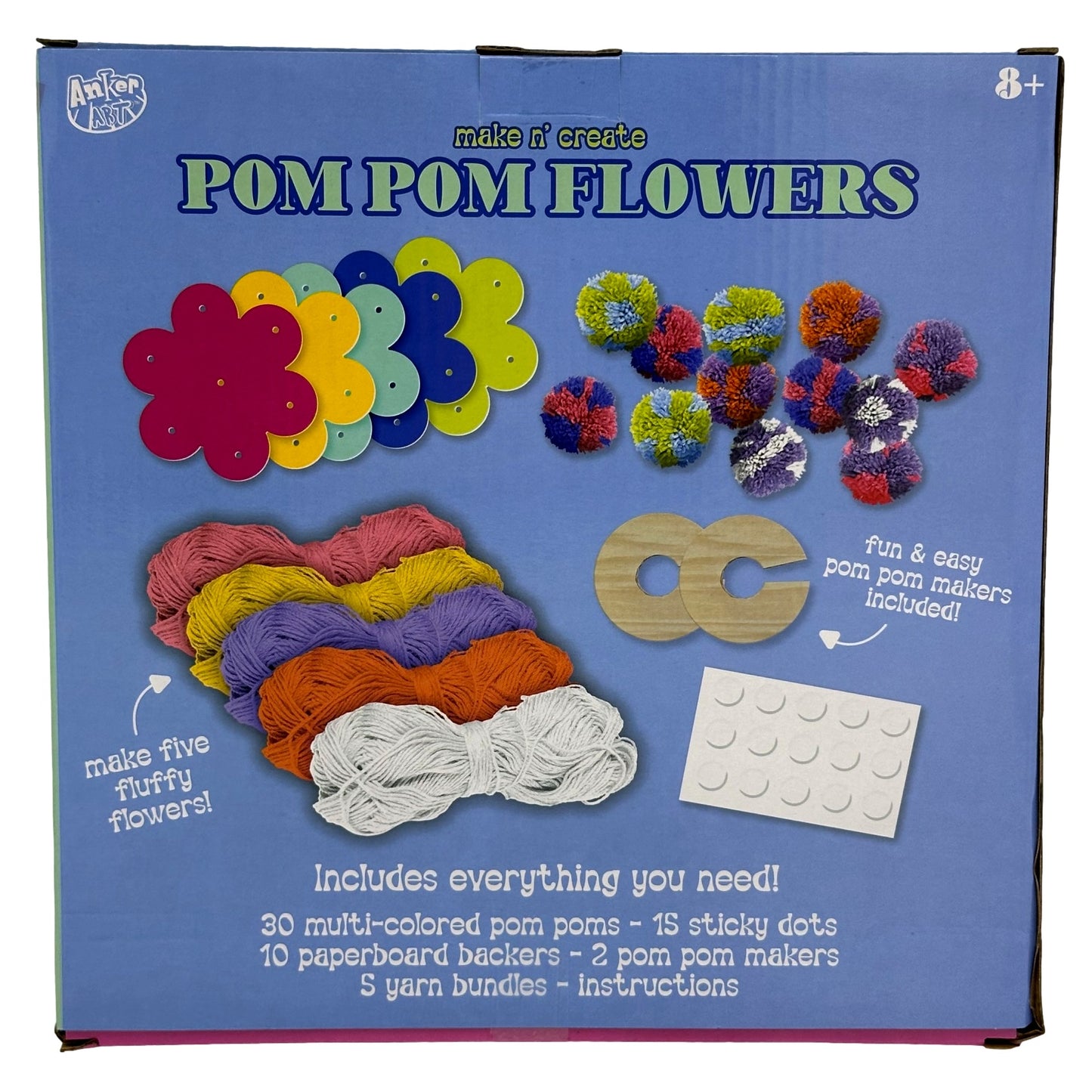 Box for a craft kit to make pom pom flowers, including yarn, paperboard backers, pom poms, pom pom makers, and sticky dots.