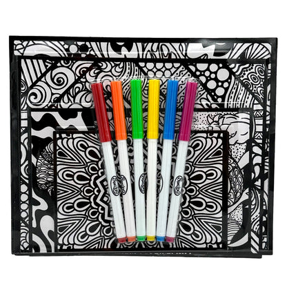 Black and white coloring book with six colorful markers on top.

