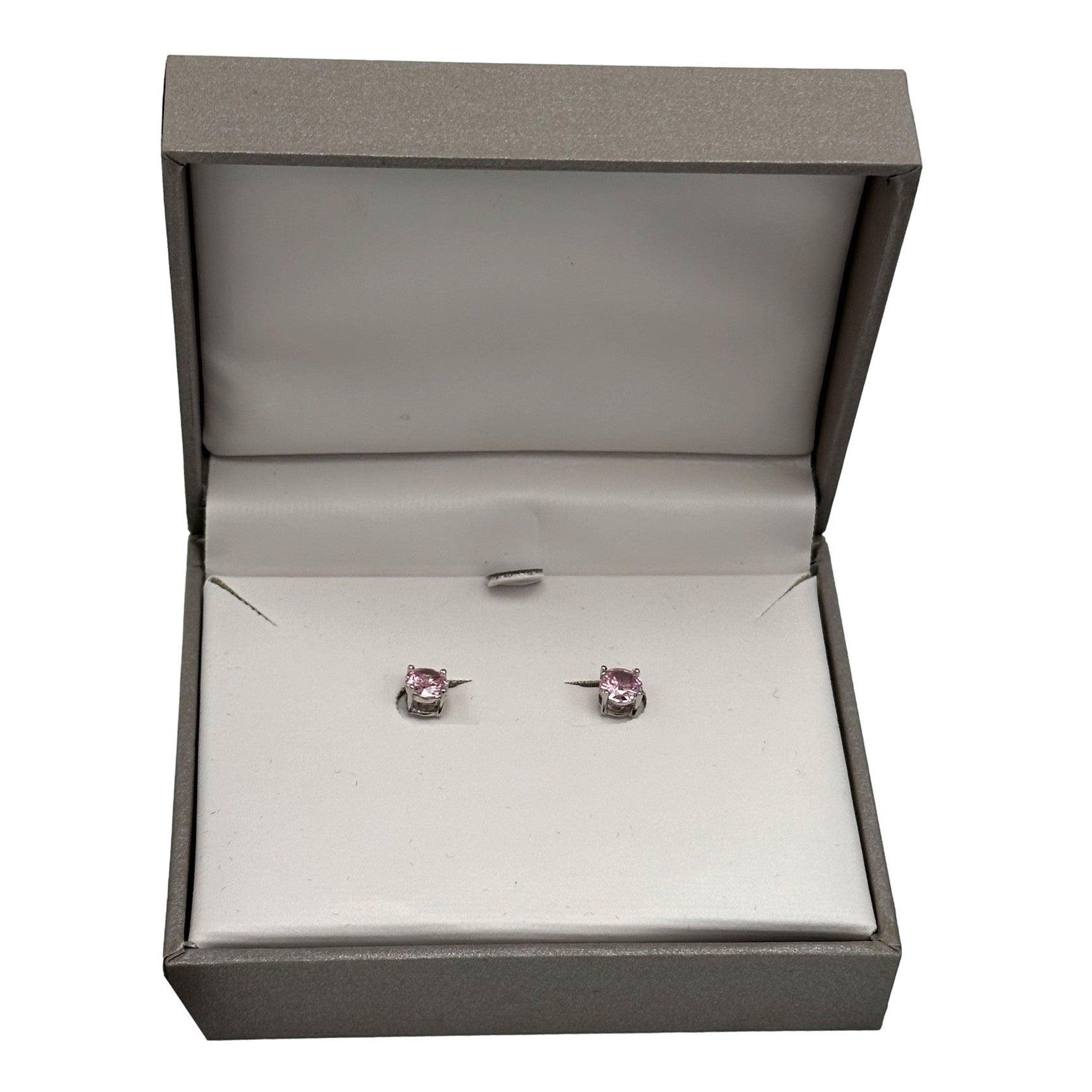 Pink stud earrings in a gray box.
