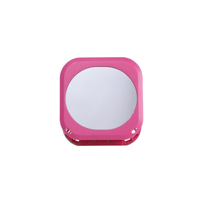 Pink compact mirror on a white background.
