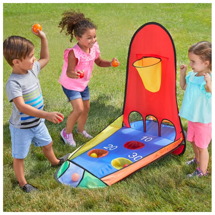 Children playing with a colorful basketball hoop on grass