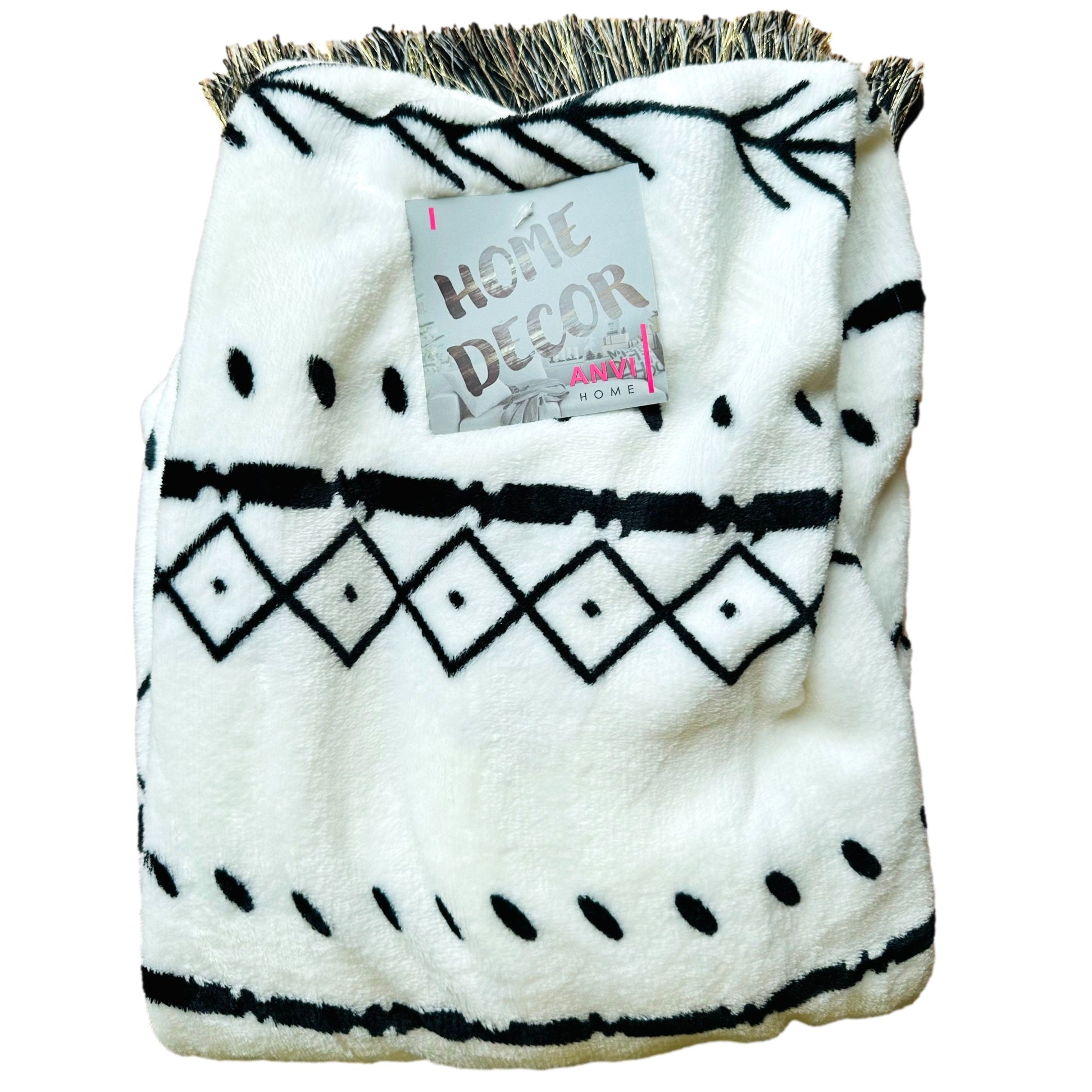 White plush blanket with black geometric pattern and fringe.